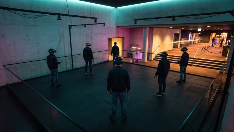 Players in headsets inside a six-player free-roam VR arena in a cinema complex foyer, an Africa VR attraction
